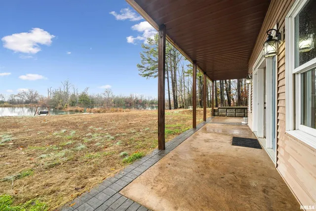 a kitchen with stainless steel appliances kitchen island granite countertop a table chairs sink and cabinets