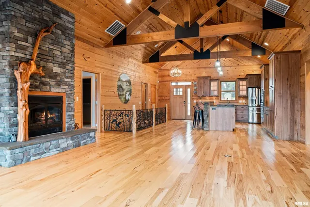 a kitchen with stainless steel appliances granite countertop lots of counter top space and wooden floor