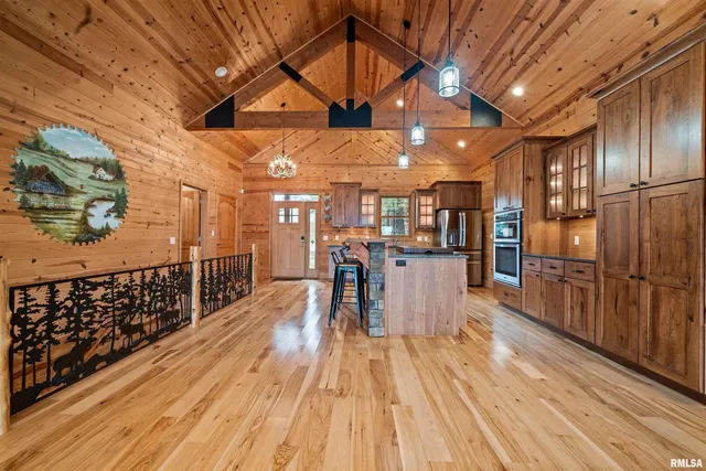 a kitchen with stainless steel appliances granite countertop lots of counter top space and wooden floor