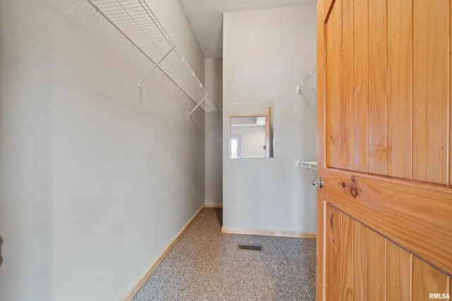 a spacious bathroom with a toilet sink and mirror