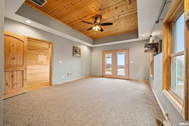an empty room with wooden floor and a window