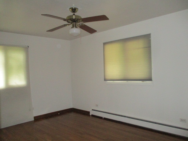 512 Highland Road Hinsdale, IL 60521 - Photo 19 of 25 an empty room with a window and a ceiling fan