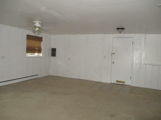 512 Highland Road Hinsdale, IL 60521 - Photo 22 of 25 an empty room with a chandelier fan