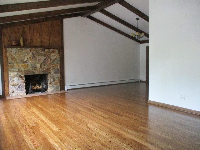 512 Highland Road Hinsdale, IL 60521 - Photo 7 of 25 a view of empty room with wooden floor and a fireplace