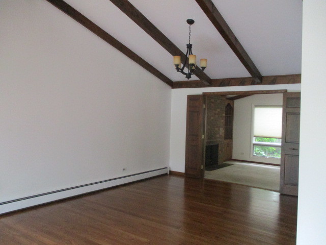 512 Highland Road Hinsdale, IL 60521 - Photo 10 of 25 a view of a hallway with wooden floor and staircase
