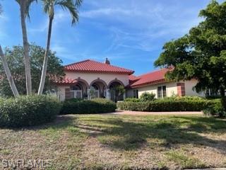 691 Ardmore Lane Naples, FL 34108 - Photo 1 of 1 a front view of a house with a yard