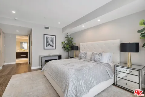 a bedroom with a bed and a night stand