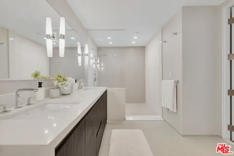 a bathroom with a double vanity sink mirror and double