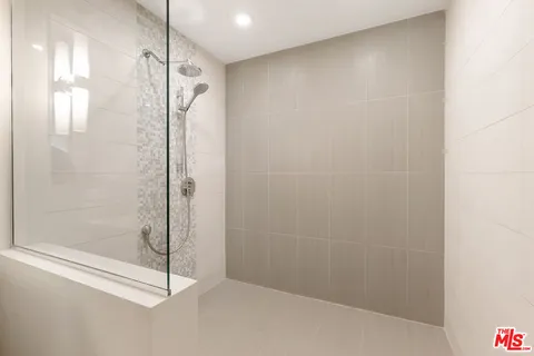 a bathroom with a glass shower door