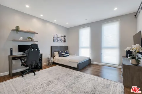 a bedroom with furniture and a window