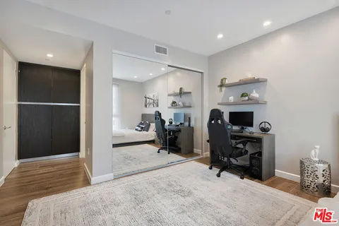 a view of a livingroom with workspace and a window