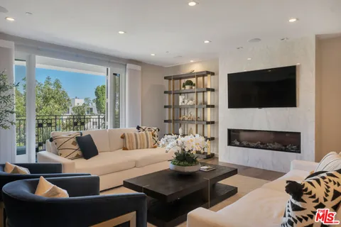 a living room with furniture fireplace and a flat screen tv
