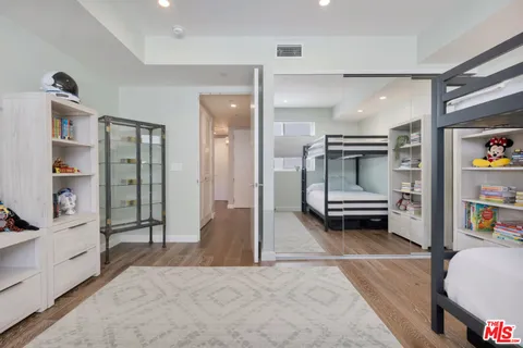 a view of a bedroom with furniture and closet