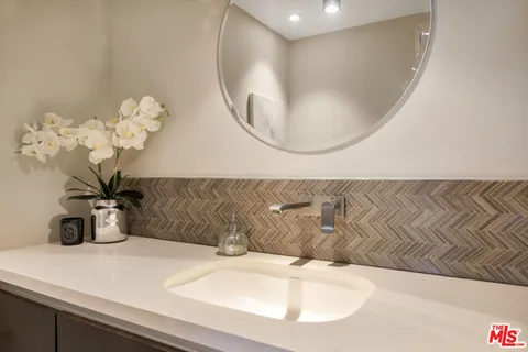 a bathroom with a sink a mirror and vanity