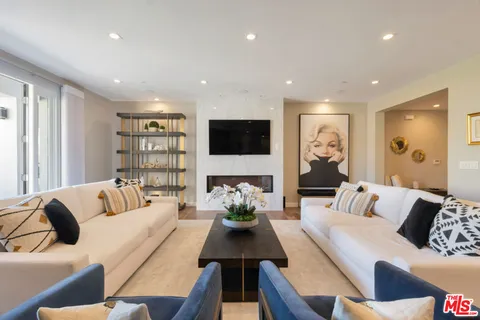 a living room with furniture a rug and a flat screen tv