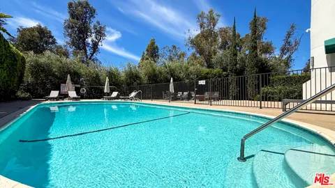 a view of a swimming pool with a patio
