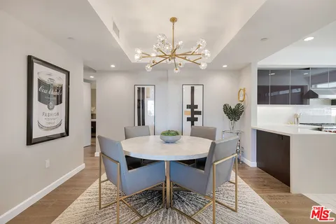 a view of a dining room with furniture and a chandelier