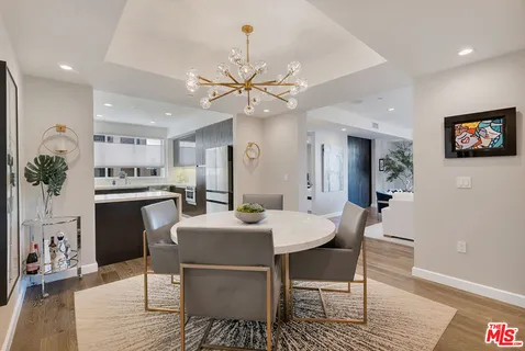 a dining room with furniture a rug and wooden floor