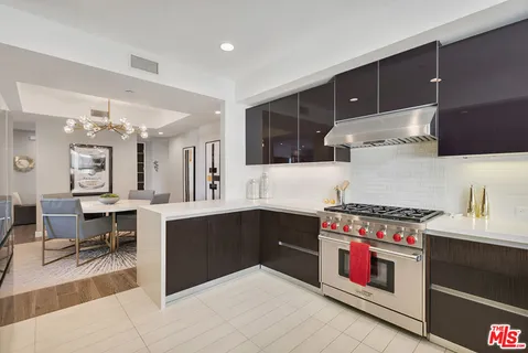 a kitchen with stainless steel appliances a stove and more cabinets