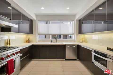 a kitchen with a sink and a stove top oven