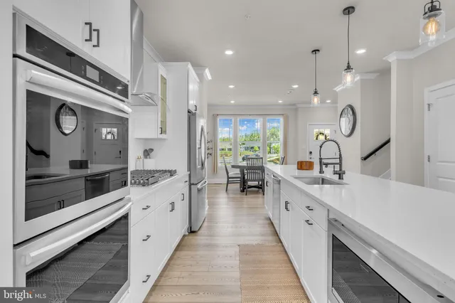 a large kitchen with stainless steel appliances kitchen island granite countertop a large counter top and sink