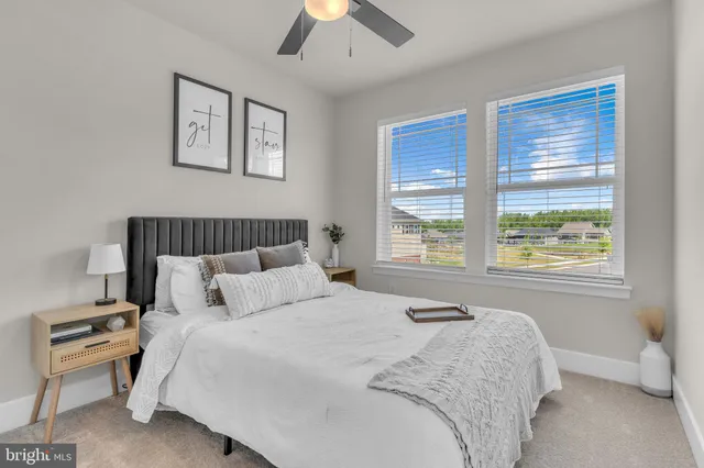 a large bed sitting in a bedroom next to a window