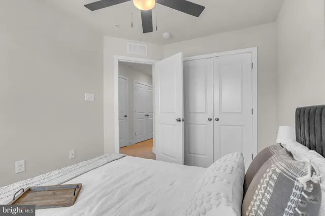 a bedroom with a bed and a chandelier