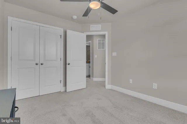 an empty room with closet area