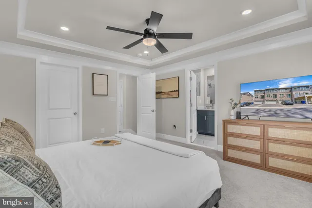 a bedroom with a bed and a ceiling fan