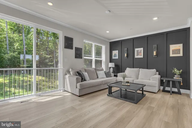 a living room with furniture and large window
