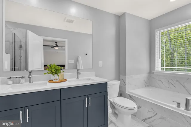 a bathroom with a sink a toilet and tub