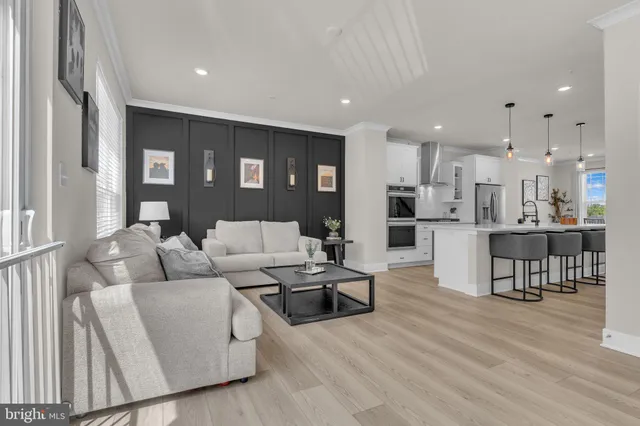 a living room with furniture and kitchen view