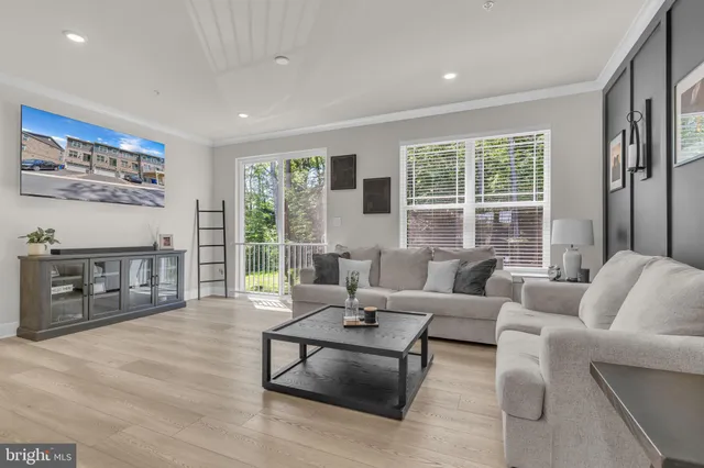 a living room with furniture and large windows