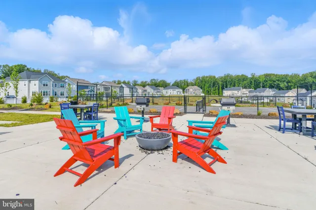 a swimming pool with outdoor seating and a garden