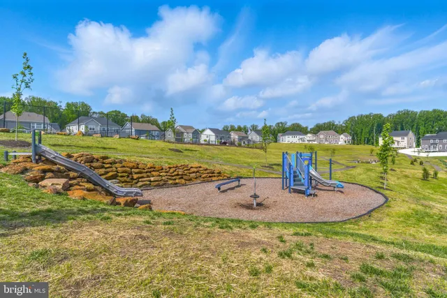a backyard of a house with lots of green space and fountain
