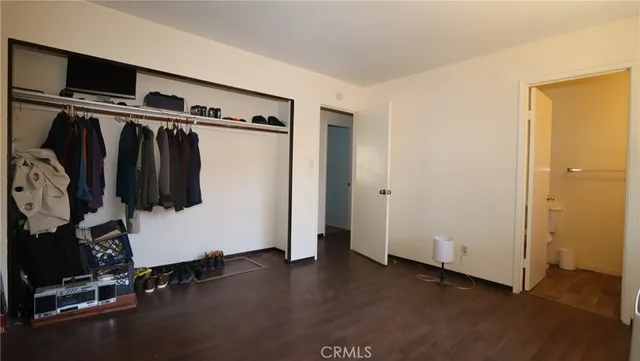 a view of walk in closet with clothes and shoes