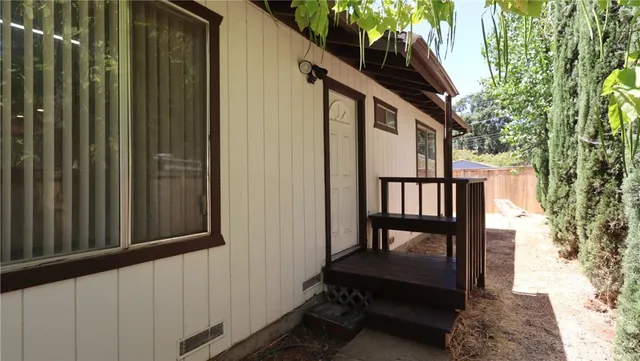 a view of a porch with furniture and a yard