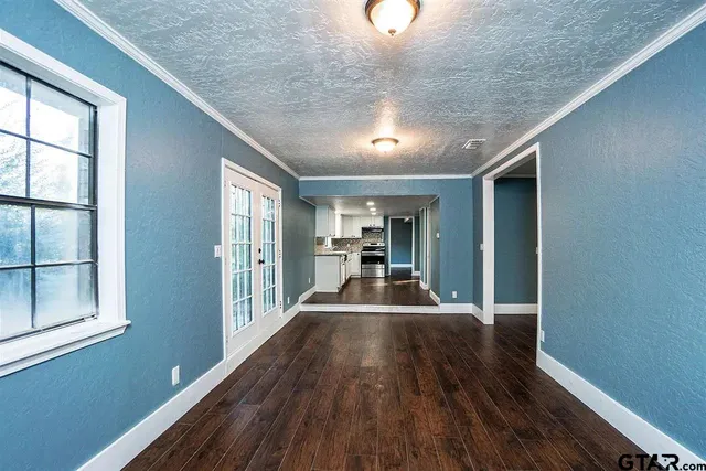 a view of a room with wooden floor and staircase