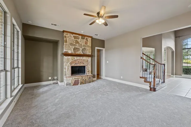 a dining room with furniture a chandelier and wooden floor