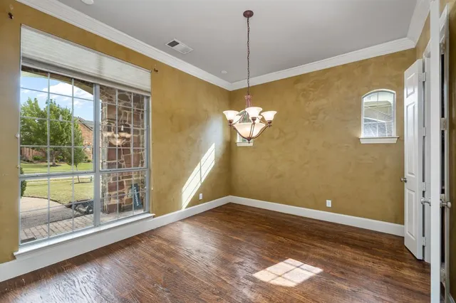 a bedroom with bed and large window