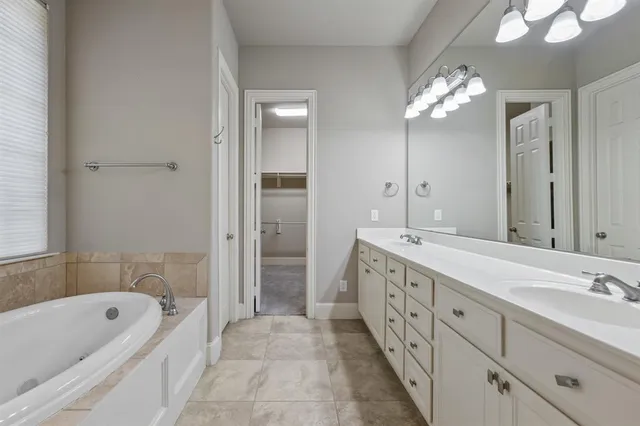 a bathroom with a tub and shower