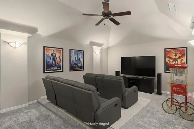 a view of a room with a ceiling fan and window