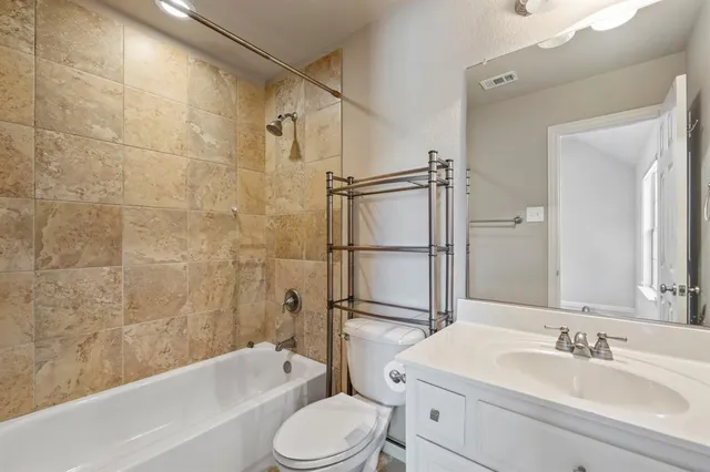 an empty room with chandelier fan and closet area