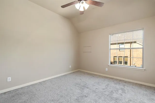 a view of room with window and ceiling fan