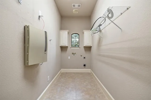 a view of a chair and table in backyard of the house