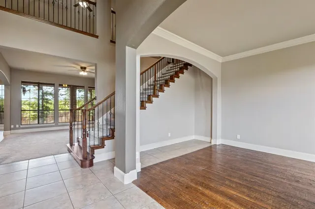 a kitchen with granite countertop a table chairs sink and cabinets