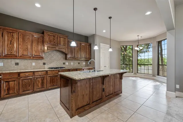 a bathroom with a sink a vanity and a large mirror
