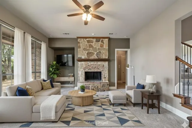 a view of an empty room with a fireplace and a window