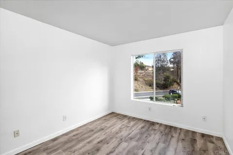 a view of a hardwood floor and a living room