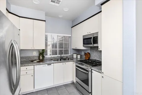 a kitchen with a refrigerator a sink and cabinets